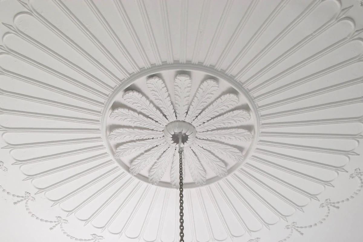 Decorative ceiling coving with ornate plaster rose