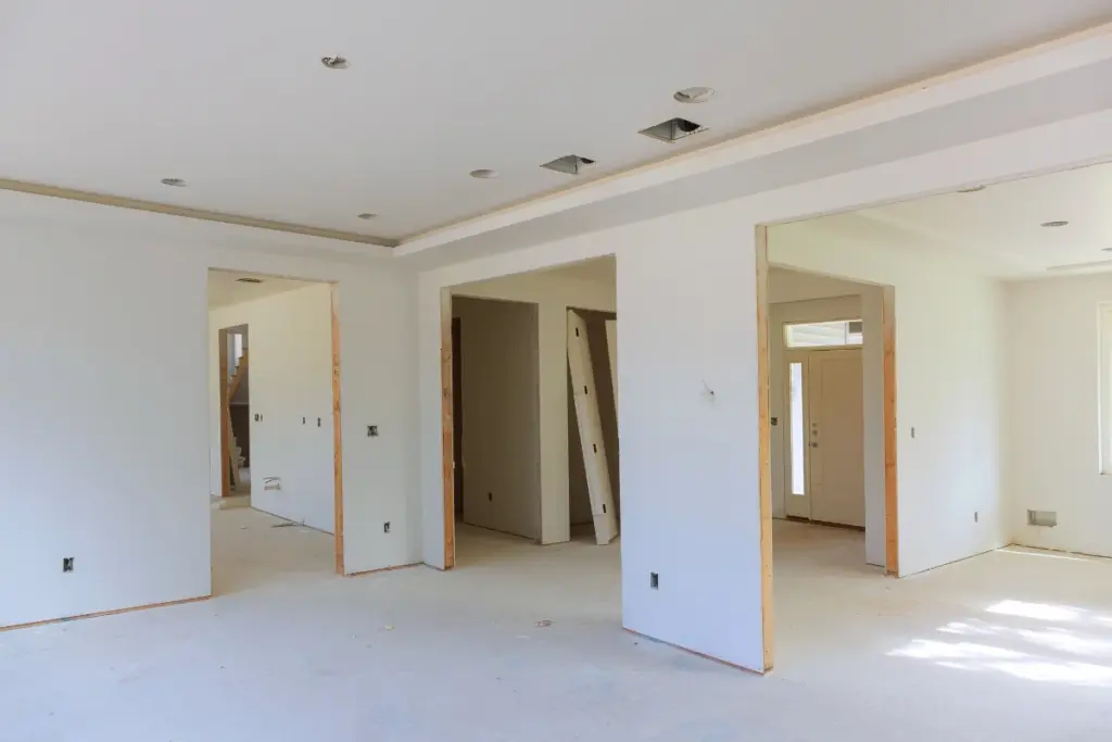 Interior under construction with new drywall walls and ceilings